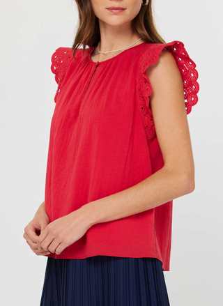 Front and back views of the Current Air Fire Fly Top: a ruby red cotton gauze blouse with scalloped crochet flutter sleeves, keyhole button closure at the round neckline, and soft gathers at the yoke, modeled with a pleated navy skirt.