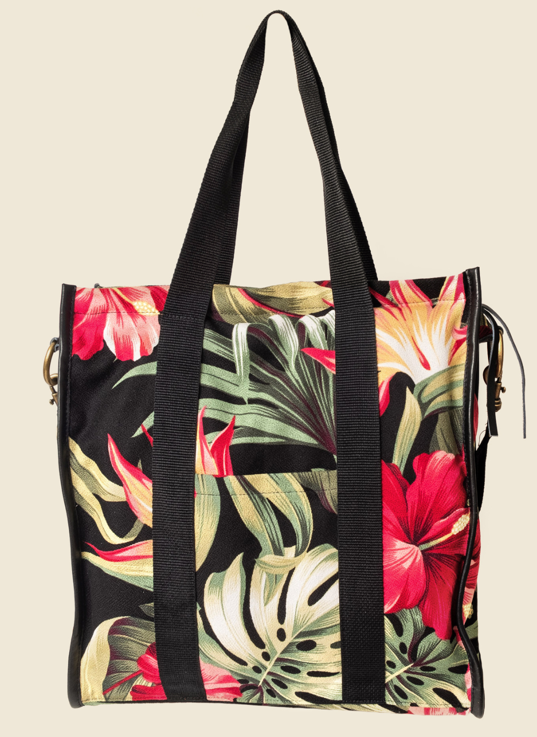 Casupo upcycled canvas and leather tote bag in tropical hibiscus print with interior zip pocket, black straps, and gold-tone hardware; handcrafted in Los Angeles.