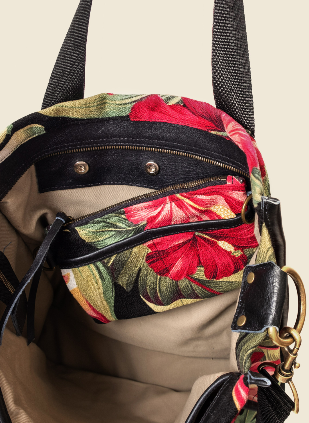 Casupo upcycled canvas and leather tote bag in tropical hibiscus print with interior zip pocket, black straps, and gold-tone hardware; handcrafted in Los Angeles.