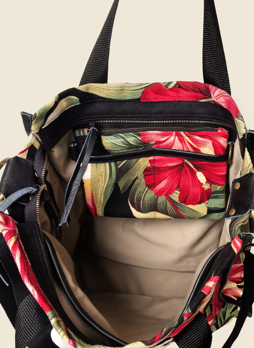 Casupo upcycled canvas and leather tote bag in tropical hibiscus print with interior zip pocket, black straps, and gold-tone hardware; handcrafted in Los Angeles.