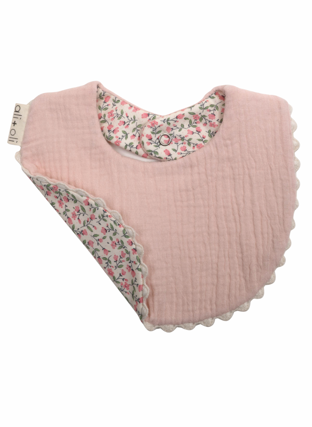 Pink baby bib with floral trim on a white background