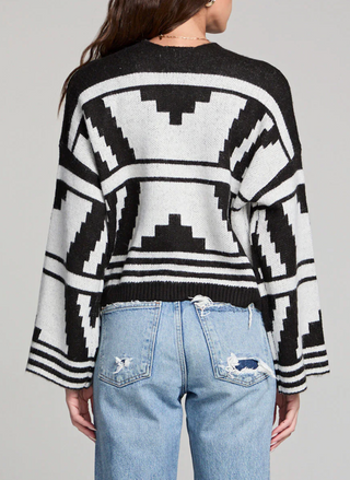Back view of Saltwater Luxe black and ivory Southwest print cardigan showing bold geometric pattern and relaxed fit.