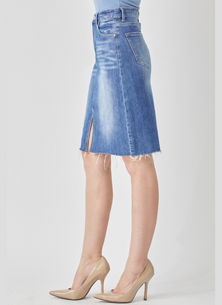 Blue denim skirt with a white background