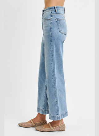 Light blue jeans worn by a person on a white background