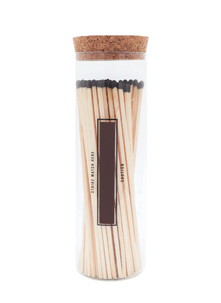 Back view of product. Tall glass round canister for 7" matches.  Back of glass jar has a strip to light matches.  Cork top.