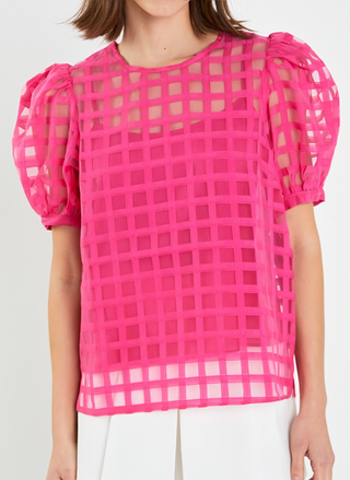 Closer view of model wearing pink Off the Grid Top with hands by her.