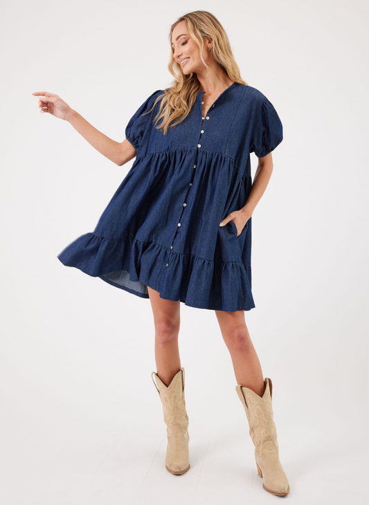 Full size view of model wearing a Paige Denim Dress and tan boots. White background.