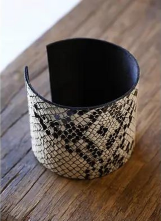 Up close picture of Snakeskin Cuff. Wooden background.