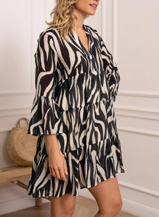 Front view of model wearing black and white St. Tropez Printed Silk Dress. Model has one hand on hip one by side. White background. 