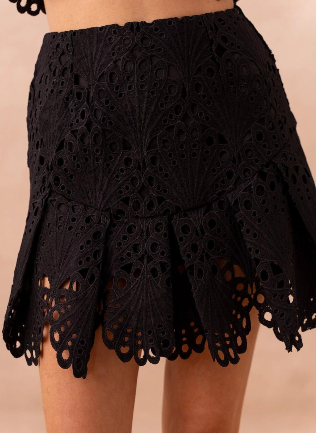 Close front view of model wearing Frenchy Lace Skirt in black. Showing the detailed lace throughout. 