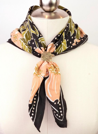 Bandana shows Gold Floral Bandana ring on a black, green, and pink printed bandana.