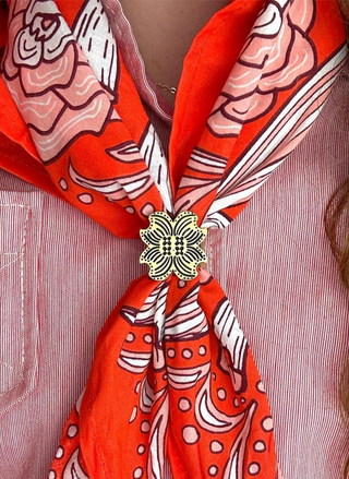 Image shows the floral bandana ring on a red patterned bandana. 