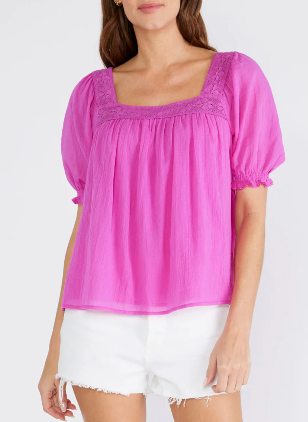 Model wearing fuchsia LS  Perry Puff Sleeve Top with lace square neckline, slight puff in the half sleeve and a fully lined bodice styled with white shorts.