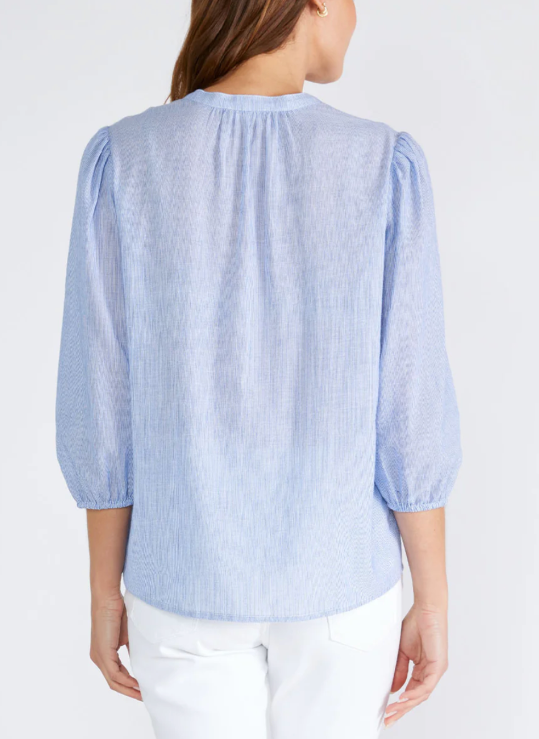 Back view of model wearing LS Cloudy Skies Top with 3/4 length sleeve and elastic cuff. Features pintuck details.