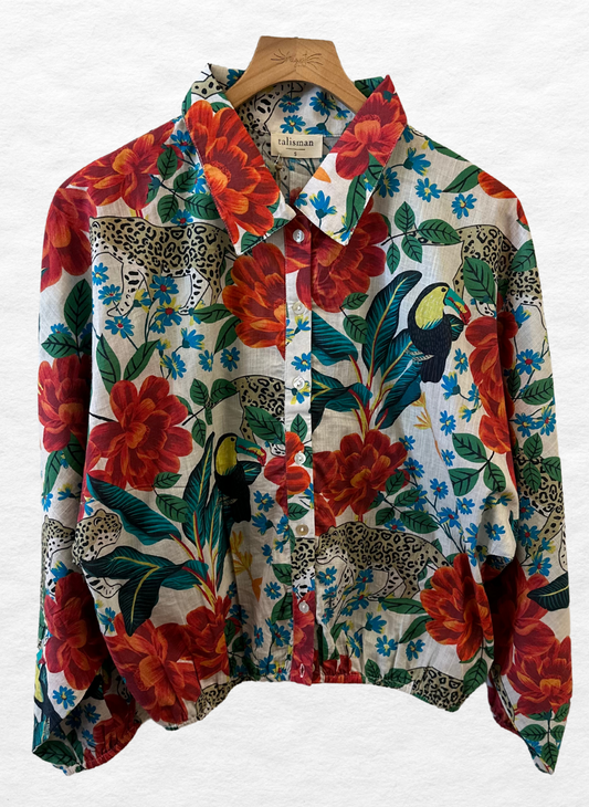 Tropical print shirt with a button front, long sleeves, elastic cuffs and a collar.