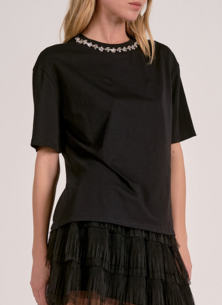 This image features the Elan Million Bucks Tee, a stylish black t-shirt that embodies elegance and luxury. The tee is designed with a sophisticated embellished neckline that adds a touch of glamour.