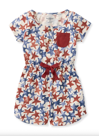 Front view of the Burt's Bees Baby American Stars Girl Romper featuring red and blue stars and a red bow.