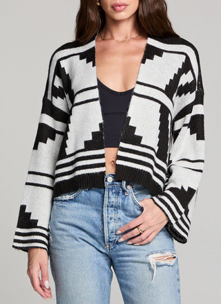 Woman wearing black and ivory Saltwater Luxe Southwest Cardi with geometric print, cropped length, and flared sleeves paired with high-waisted jeans.