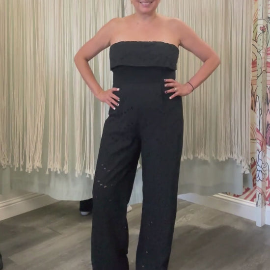 Video of model wearing black Stella jumpsuit. Full body view.