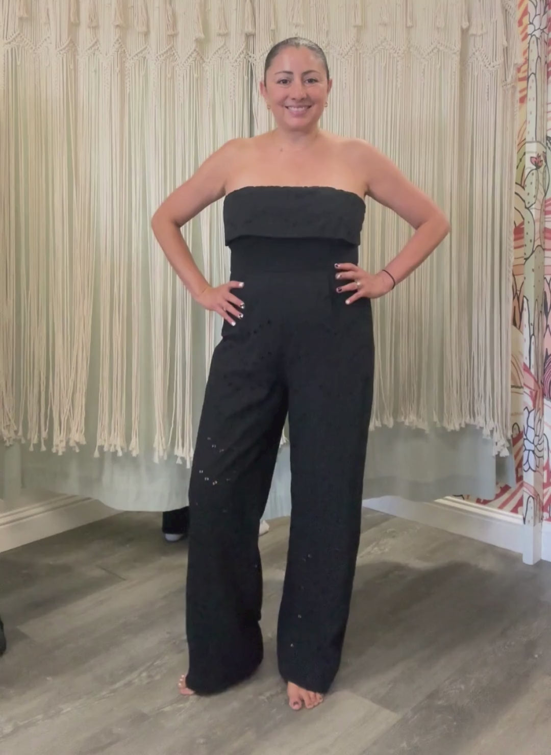 Video of model wearing black Stella jumpsuit. Full body view.