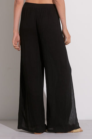 Back view of a woman wearing white cotton gauze wide leg wrap pants with tie front and knee-high side slit – lightweight summer pants for women